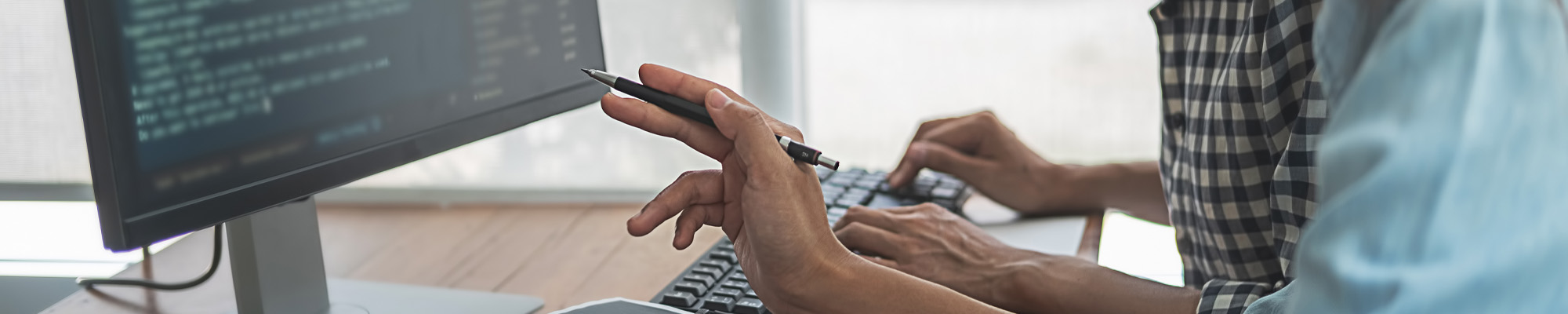 two people sitting at computer